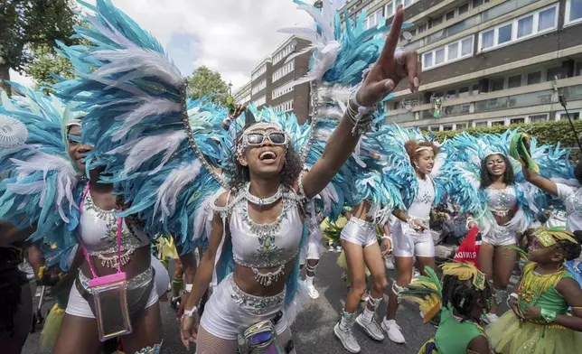 Participants taking part in the Children's Day Parade, part of the Notting Hill Carnival celebration in west London, Sunday, Aug. 25, 2024. (Jeff Moore/PA via AP)