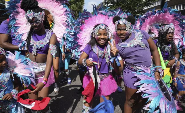 Participants take part in the Children's Day Parade, part of the Notting Hill Carnival celebration in west London, Sunday Aug. 25, 2024. (Jeff Moore/PA via AP)