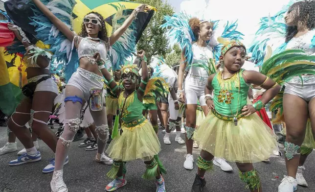 Participants taking part in the Children's Day Parade, part of the Notting Hill Carnival celebration in west London, Sunday, Aug. 25, 2024. (Jeff Moore/PA via AP)