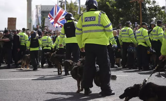 Heavy police presence as people protest in Liverpool, England, Saturday Aug. 3, 2024, following the stabbing attacks on Monday in Southport, in which three young children were killed. (James Speakman/PA via AP)