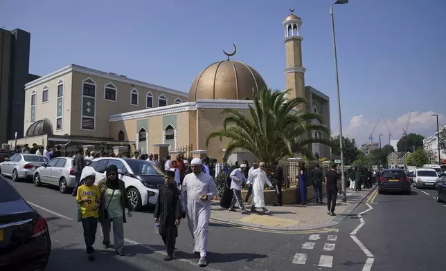 Worshippers leaves after taking part in Friday Prayers at the London Islamic Cultural Society (LICS) and Mosque in Haringey, north London, Friday, Aug. 2, 2024. Hundreds of mosques across the country are strengthening their security and protective measures ahead of planned protests, the Muslim Council of Britain (MCB) has said. There are fears that Islamic places of worship could be targeted during demonstrations expected to take place over the weekend following the Southport stabbing attack. (Jonathan Brady/PA via AP)