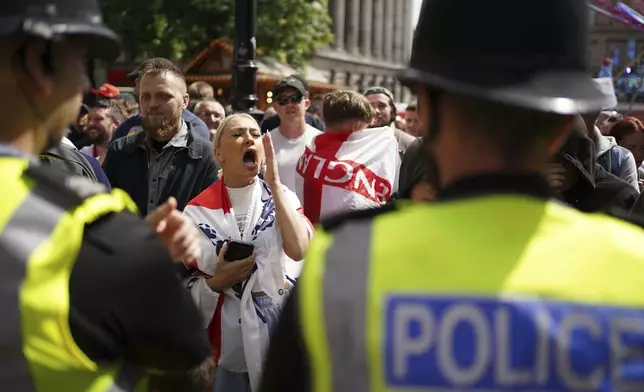 People protest in Liverpool, England, Saturday Aug. 3, 2024, following the stabbing attacks on Monday in Southport, in which three young children were killed. (James Speakman/PA via AP)