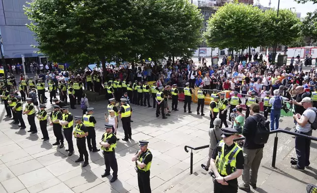 Heavy police presence as people protest outside Leeds Town Hall, England, Saturday Aug. 3, 2024, following the stabbing attacks on Monday in Southport, in which three young children were killed. (Owen Humphreys/PA via AP)