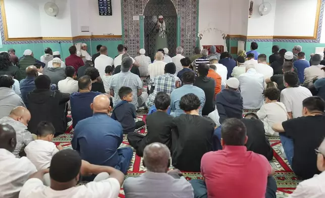 Imam Foysol Ahmed leads Friday Prayers at the London Islamic Cultural Society (LICS) and Mosque in Haringey, north London, Friday, Aug. 2, 2024. Hundreds of mosques across the country are strengthening their security and protective measures ahead of planned protests, the Muslim Council of Britain (MCB) has said. There are fears that Islamic places of worship could be targeted during demonstrations expected to take place over the weekend following the Southport stabbing attack. (Jonathan Brady/PA via AP)