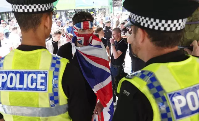 People protest in Leeds, England, Saturday Aug. 3, 2024, following the stabbing attacks on Monday in Southport, in which three young children were killed. (Owen Humphreys/PA via AP)