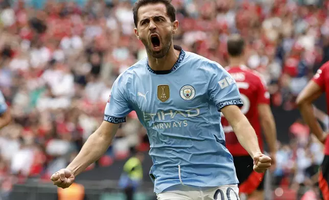 Manchester City midfielder Bernardo Silva celebrates scoring his side's first goal during the FA Community Shield soccer match between Manchester City and Manchester United at Wembley Stadium in London, Saturday, Aug. 10, 2024. (AP Photo/David Cliff)