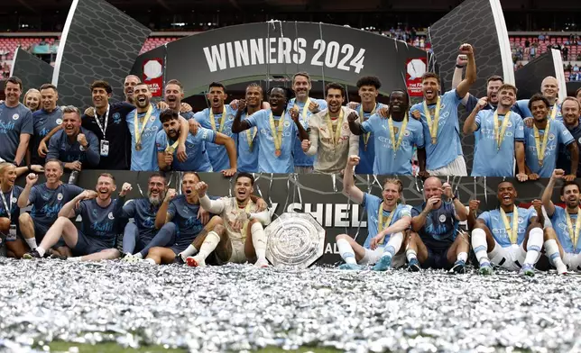 Manchester City players celebrate winning the FA Community Shield soccer match between Manchester City and Manchester United by penalty shootout at Wembley Stadium in London, Saturday, Aug. 10, 2024. (AP Photo/David Cliff)