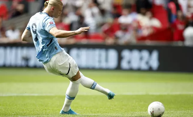 Manchester City forward Erling Haaland kicks a penalty during the FA Community Shield soccer match between Manchester City and Manchester United at Wembley Stadium in London, Saturday, Aug. 10, 2024. (AP Photo/David Cliff)