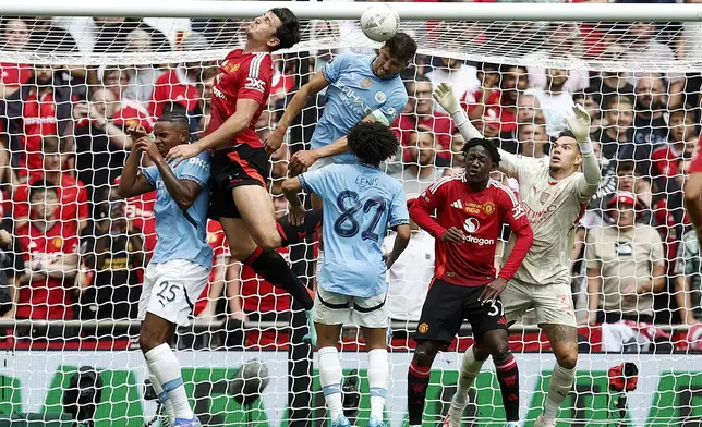 Manchester City defender Ruben Dias heads the ball during the FA Community Shield final soccer match between Manchester City and Manchester United at Wembley Stadium in London, Saturday, Aug. 10, 2024. (AP Photo/David Cliff)