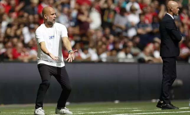 Manchester City's head coach Pep Guardiola gestures during the FA Community Shield final soccer match between Manchester City and Manchester United at Wembley Stadium in London, Saturday, Aug. 10, 2024. (AP Photo/David Cliff)