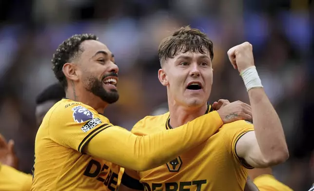 Wolverhampton Wanderers' Jorgen Strand Larsen, right, celebrates scoring with teammate Matheus Cunha during the English Premier League soccer match between Wolverhampton Wanderers and Chelsea at Molineux Stadium, Wolverhampton, England. Sunday Aug. 25, 2024. (Joe Giddens/PA via AP)