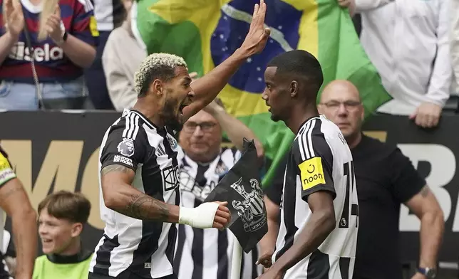 Newcastle United's Joelinton, left, celebrates scoring with teammate Alexander Isak during the English Premier League soccer match between Newcastle United and Southampton at St James' Park, Newcastle, England, Saturday Aug. 17, 2024. (Owen Humphreys/PA via AP)