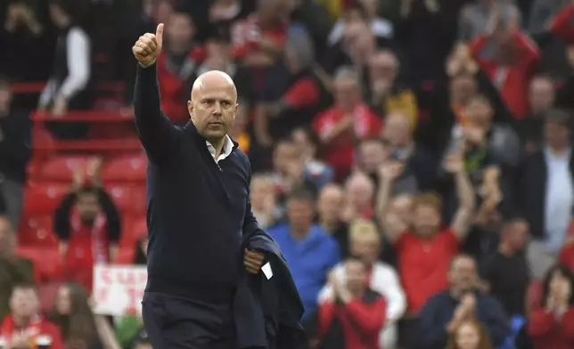 Liverpool's manager Arne Slot walks on the pitch at the end of the English Premier League soccer match between Liverpool and Brentford at Anfield Stadium, Liverpool, England, Sunday, Aug. 25, 2024. (AP Photo/Rui Vieira)