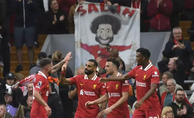 Liverpool's Mohamed Salah, centre, celebrates with teammates after scoring his side's second goal during the English Premier League soccer match between Liverpool and Brentford at Anfield Stadium, Liverpool, England, Sunday, Aug. 25, 2024. (AP Photo/Rui Vieira)