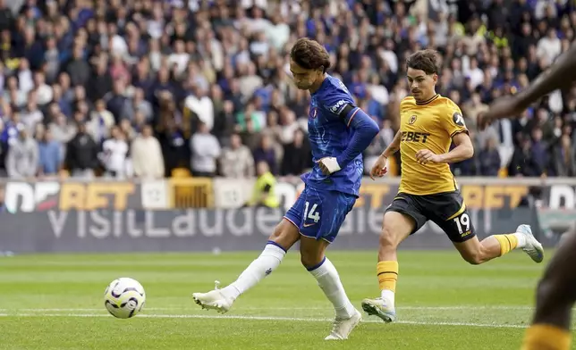 Chelsea's Joao Felix scores his sides sixth goal of the game during the English Premier League soccer match between Wolverhampton Wanderers and Chelsea at Molineux Stadium, Wolverhampton, England, Sunday Aug. 25, 2024. (Joe Giddens/PA via AP)