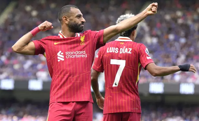 Liverpool's Mohamed Salah, left, celebrates after he scores his side's second goal during the English Premier League soccer match between Ipswich Town and Liverpool at Portman Road stadium in Ipswich, England, Saturday, Aug. 17, 2024. (AP Photo/Alastair Grant)