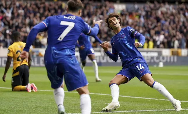 Chelsea's Joao Felix, right, celebrates scoring his sides sixth goal of the game during the English Premier League soccer match between Wolverhampton Wanderers and Chelsea at Molineux Stadium, Wolverhampton, England, Sunday Aug. 25, 2024. (Joe Giddens/PA via AP)