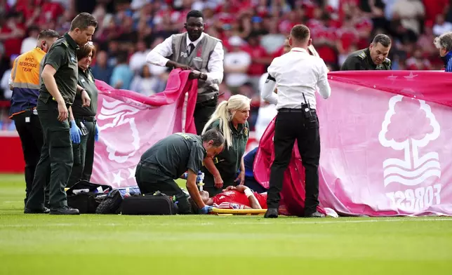 Nottingham Forest's Danilo receive treatment as covers are placed around him during the British Premier League soccer match between Nottingham Forest and AFC Bournemouth, at the City Ground, Nottingham, England, Saturday Aug. 17, 2024. (Mike Egerton/PA via AP)