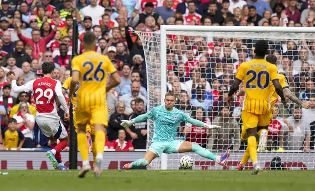 Brighton's goalkeeper Bart Verbruggen, center, makes a save in front of Arsenal's Kai Havertz, left, during the English Premier League soccer match between Arsenal and Brighton, at Emirates Stadium in London, Saturday, Aug. 31, 2024. (AP Photo/Alastair Grant)