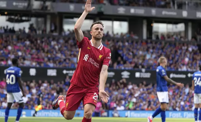 Liverpool's Diogo Jota celebrates after he scores his side's first goal during the English Premier League soccer match between Ipswich Town and Liverpool at Portman Road stadium in Ipswich, England, Saturday, Aug. 17, 2024. (AP Photo/Alastair Grant)