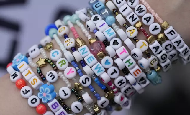 Taylor Swift fan, Amy Willow, wears wrist bands that have names of Swift songs on them outside Wembley Stadium in London, Wednesday, Aug. 14, 2024, ahead of a series of Swift concerts starting Thursday. (AP Photo/Alastair Grant)