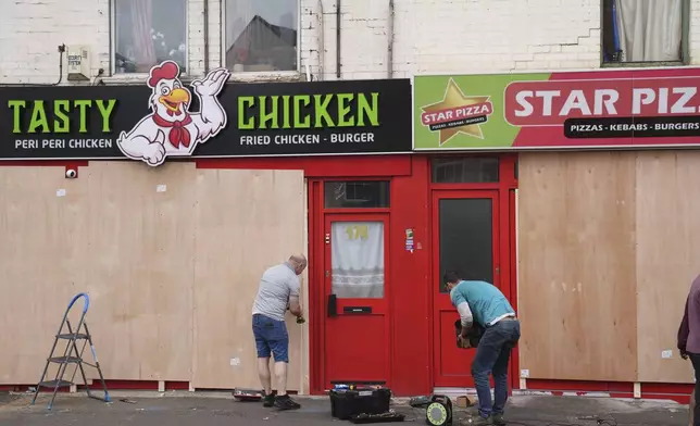 Windows are boarded up ahead of an anti-immigration protest in Northampton, England, Wednesday, Aug. 7, 2024. (Joe Giddens/PA via AP)