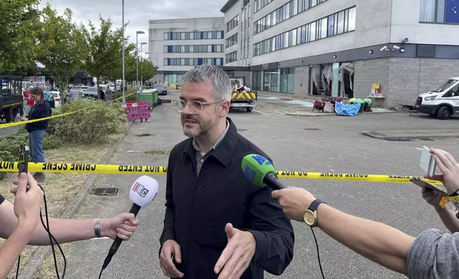 Oliver Coppard, South Yorkshire Mayor, speaks to the media outside the Holiday Inn Express where anti-immigration rioters smashed the windows before starting fires on Sunday, in Rotherham, England, Monday, Aug. 5, 2024. Lawlessness has swept the country over the past six days as right-wing activists used social media to spread misinformation to whip up anger over a stabbing rampage at a dance class that left three girls dead and many more wounded. (Dave Higgens/PA Wire/PA via AP)