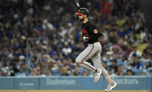 CORRECTS TO COLTON COWSER INSTEAD OF JACKSON HOLIDAY - Baltimore Orioles' Colton Cowser heads to second for a three-run home run during the fifth inning of a baseball game against the Los Angeles Dodgers, Thursday, Aug. 29, 2024, in Los Angeles. (AP Photo/Mark J. Terrill)