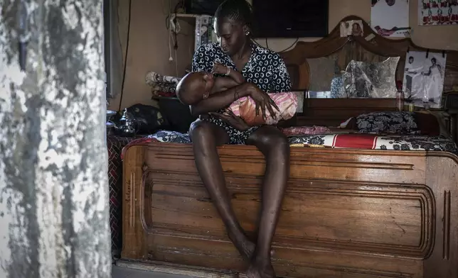 CORRECTS FAMILY NAME TO NDIAYE - Salamba Ndiaye, a 28-year-old who tried to migrate to Europe twice, is photographed in her family house in Thiaroye-Sur-Mer, Senegal, Friday, Aug. 23, 2024. Ndiaye is one of thousands of young Senegalese who try to flee poverty and the lack of job opportunities in the West African country each year to head to Spain. More than 22,300 people have landed on the Canary Islands from January to mid-August this year. (AP Photo/Annika Hammerschlag)