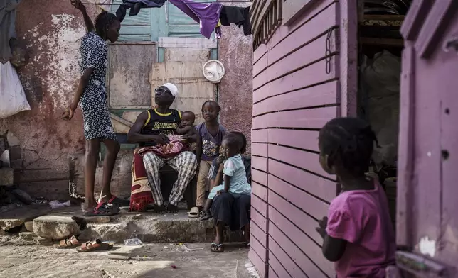 CORRECTS FAMILY NAME TO NDIAYE - Salamba Ndiaye, left, a 28-year-old who tried to migrate to Europe twice, speaks with family members in Thiaroye-Sur-Mer, Senegal, Friday, Aug. 23, 2024. Ndiaye is one of thousands of young Senegalese who try to flee poverty and the lack of job opportunities in the West African country each year to head to Spain. More than 22,300 people have landed on the Canary Islands from January to mid-August this year. (AP Photo/Annika Hammerschlag)