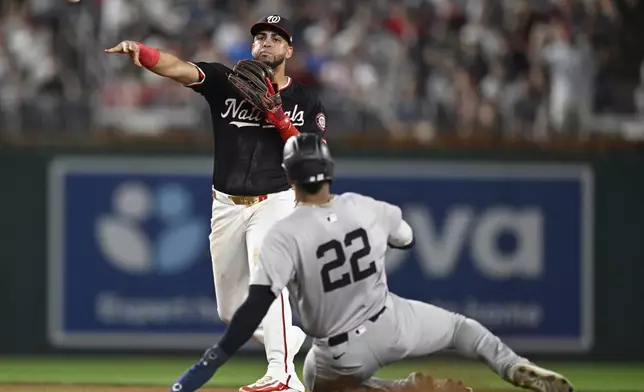 CORRECTION - CLARIFIES OUTS. Washington Nationals second baseman Luis García Jr., left, turns for the first two outs on New York Yankees' Juan Soto to end the eighth inning of a baseball game, Tuesday, Aug. 27, 2024, in Washington. (AP Photo/John McDonnell)