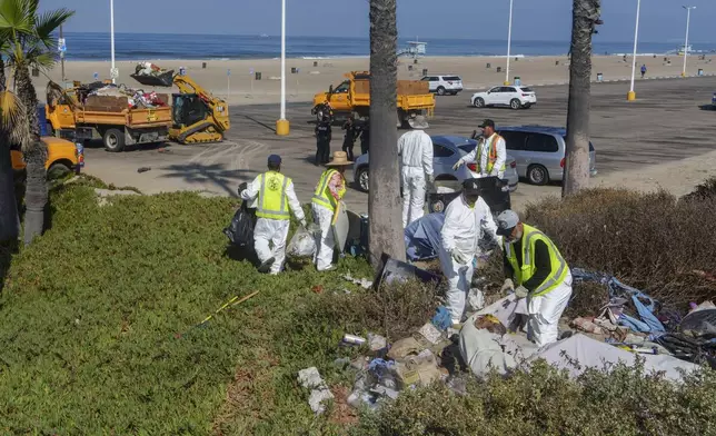 City of Los Angeles Recreation and Parks and sanitation crews remove homeless encampment at the Dockweiler State Beach in Playa del Rey, Los Angeles, Thursday, Aug. 22, 2024. (AP Photo/Damian Dovarganes)