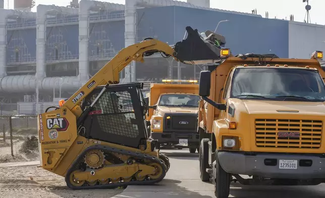 City of Los Angeles Recreation and Parks crews remove homeless encampments near the Hyperion Water Reclamation Plant, a sewage treatment plant, at the Dockweiler State Beach in Playa del Rey, Los Angeles, on Thursday, Aug. 22, 2024. (AP Photo/Damian Dovarganes)