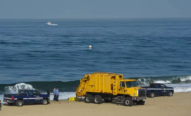 Los Angeles police and Los Angeles County Department of Beaches and Harbors workers conduct a cleanup operation to remove homeless encampments at Dockweiler State Beach in Playa del Rey, Los Angeles, Thursday, Aug. 22, 2024. (AP Photo/Damian Dovarganes)