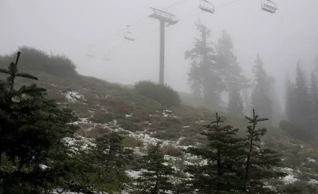 FILE - A coating of snow is seen below ski lifts at Sugarbowl Ski Resort Saturday, Aug. 24, 2024, in Donner Summit, Calif. (AP Photo/Brooke Hess-Homeier, File)