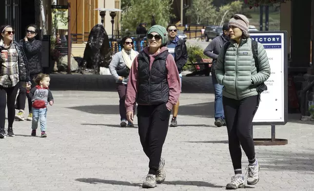 Visitors bundle up as temperatures drop ahead of a storm at the Palisades Tahoe Ski Resort Friday, Aug. 23, 2024, in Olympic Valley, Calif. (AP Photo/Brooke Hess-Homeier)