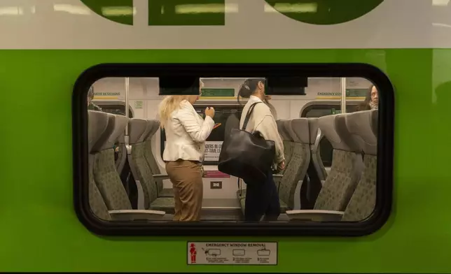 Commuters arrive at Union Station on a GO Train as a national rail shutdown causes delays in Toronto, Thursday, Aug. 22, 2024. (Paige Taylor White /The Canadian Press via AP)