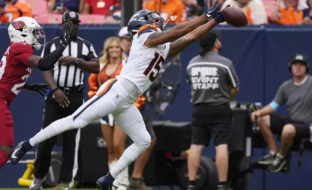 Denver Broncos wide receiver Jalen Virgil (15) is unable to make a catch as Arizona Cardinals cornerback Michael Ojemudia, left, defends during the second half of a preseason NFL football game Sunday, Aug. 25, 2024, in Denver. (AP Photo/David Zalubowski)