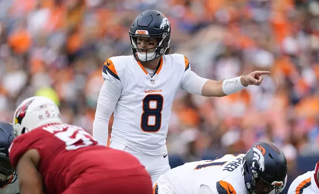 Denver Broncos quarterback Jarrett Stidham signals to his players during the first half of a preseason NFL football game against the Denver Broncos, Sunday, Aug. 25, 2024, in Denver. (AP Photo/David Zalubowski)