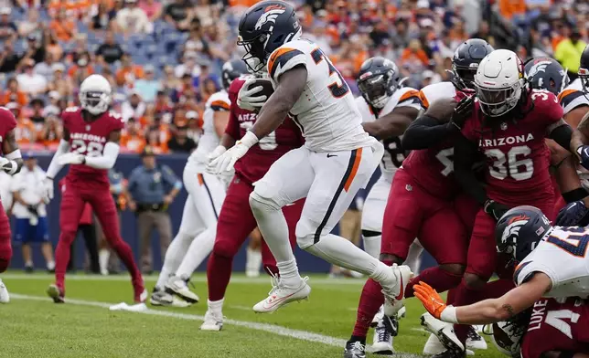 Denver Broncos running back Audric Estime scores a touchdown against the Arizona Cardinals during the first half of a preseason NFL football game Sunday, Aug. 25, 2024, in Denver. (AP Photo/Jack Dempsey)