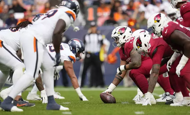 The Arizona Cardinals, right, and the Denver Broncos, left, line up for a play during the second half of a preseason NFL football game Sunday, Aug. 25, 2024, in Denver. (AP Photo/Jack Dempsey)