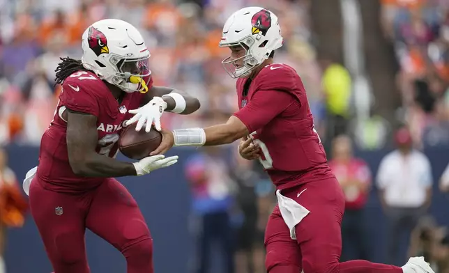 Arizona Cardinals quarterback Clayton Tune, right, hands the ball off to Cardinals running back Tony Jones Jr. (37) during the first half of a preseason NFL football game Sunday, Aug. 25, 2024, in Denver. (AP Photo/Jack Dempsey)