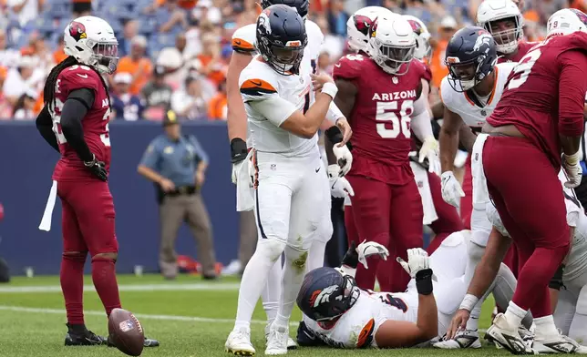 Denver Broncos quarterback Zach Wilson, center, celebrates his touchdown run against the Arizona Cardinals during the second half of a preseason NFL football game Sunday, Aug. 25, 2024, in Denver. (AP Photo/Jack Dempsey)