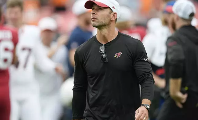 Arizona Cardinals head coach Jonathan Gannon walks the sideline in the closing moments of the second half of a preseason NFL football game against the Denver Broncos, Sunday, Aug. 25, 2024, in Denver. The Broncos won 38-12. (AP Photo/David Zalubowski)