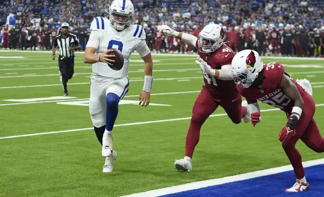 Indianapolis Colts quarterback Jason Bean (8) runs for a touchdown by beating Arizona Cardinals linebacker Markus Bailey (41) and Cardinals safety Verone McKinley III, right, during the second half of a preseason NFL football game, Saturday, Aug. 17, 2024, in Indianapolis. (AP Photo/Darron Cummings)