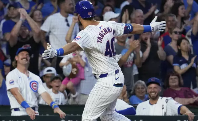 Chicago Cubs' Mike Tauchman, center, celebrates after hitting a solo home run during the sixth inning of a baseball game against the St. Louis Cardinals in Chicago, Sunday, Aug. 4, 2024. (AP Photo/Nam Y. Huh)