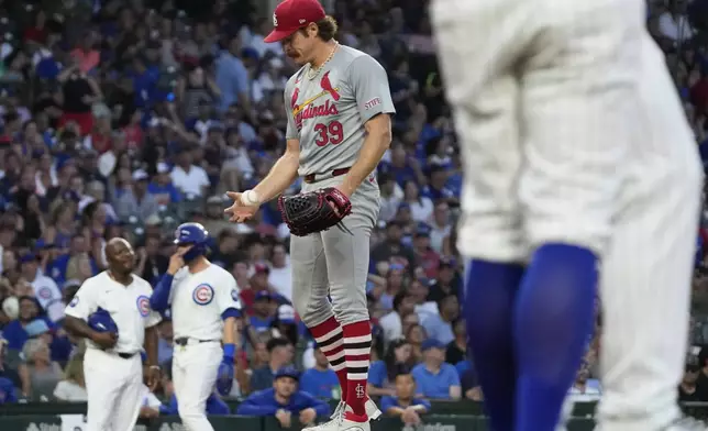 St. Louis Cardinals starting pitcher Miles Mikolas (39) tosses a ball after Chicago Cubs' Michael Busch hit a one-run single during the fifth inning of a baseball game in Chicago, Sunday, Aug. 4, 2024. (AP Photo/Nam Y. Huh)