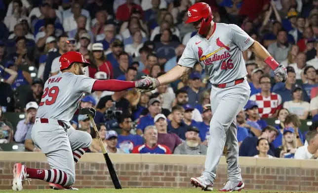 St. Louis Cardinals' Paul Goldschmidt, right, is greeted by Tommy Pham, left, after scoring against the Chicago Cubs during the seventh inning of a baseball game Thursday, Aug. 1, 2024, in Chicago. (AP Photo/David Banks)