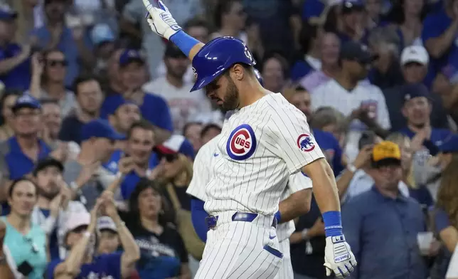 Chicago Cubs' Mike Tauchman celebrates as he rounds the bases after hitting a solo home run during the sixth inning of a baseball game against the St. Louis Cardinals in Chicago, Sunday, Aug. 4, 2024. (AP Photo/Nam Y. Huh)