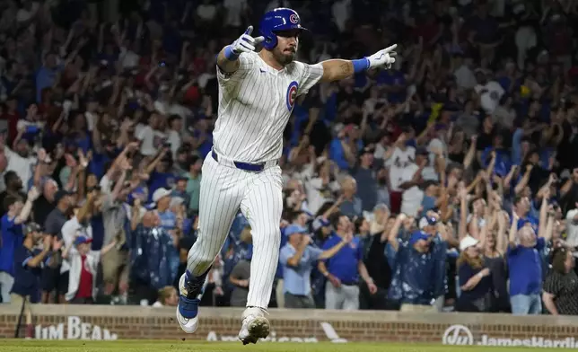 Chicago Cubs pinch hitter Mike Tauchman reacts after hitting a walkoff single against the St. Louis Cardinals during the ninth inning of a baseball game Thursday, Aug. 1, 2024, in Chicago. (AP Photo/David Banks)